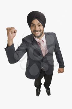 Businessman smiling with his hand raised