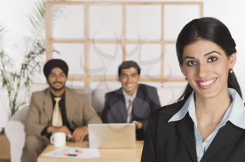 Portrait of a businesswoman with her colleagues in the background