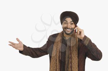 Sikh man talking on a mobile phone and gesturing