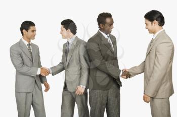 Four businessmen shaking hands