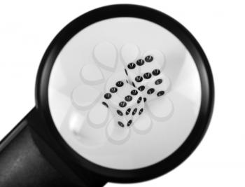 Close-up of a magnifying glass with dices