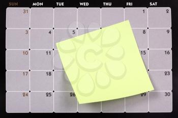 Adhesive note attached with a calendar