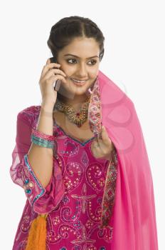 Woman wearing a salwar kameez and talking on a mobile phone