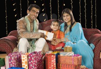 Couple giving gifts to their son on Diwali festival