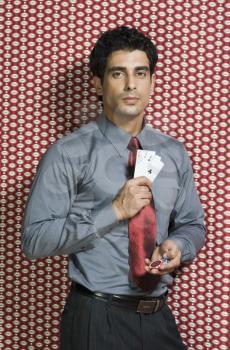 Man holding three aces and gambling chips