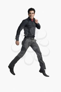 Portrait of a man jumping against a white background