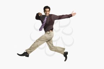 Portrait of a businessman leaping against a white background