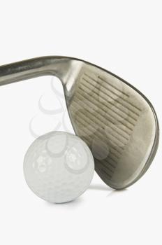 Close-up of a golf club with a golf ball