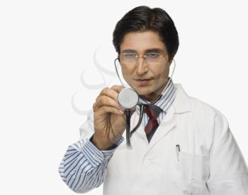 Doctor pretending to listen heartbeat with a stethoscope