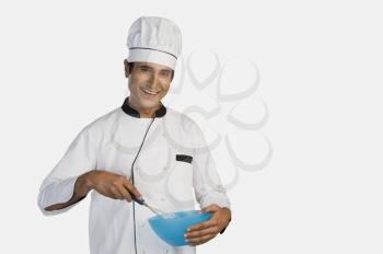 Portrait of a chef holding a mixing bowl