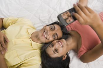 Close-up of a couple taking a picture of themselves with a camera phone