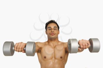 Portrait of a man exercising with dumbbells