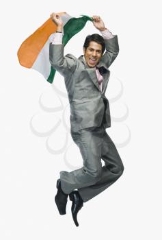 Businessman jumping with holding Indian flag