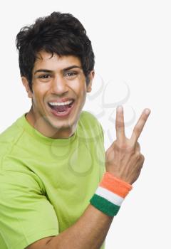 Portrait of a man showing peace sign