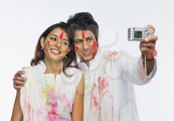 Couple taking a picture of themselves on Holi