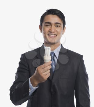 Businessman holding a CFL bulb