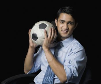 Businessman holding a soccer ball