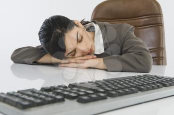 Businesswoman sleeping at desk
