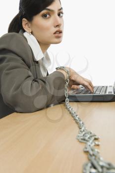 Businesswoman chained to her desk