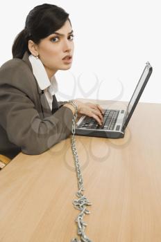 Businesswoman chained to her desk