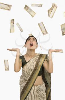 Money falling over a woman