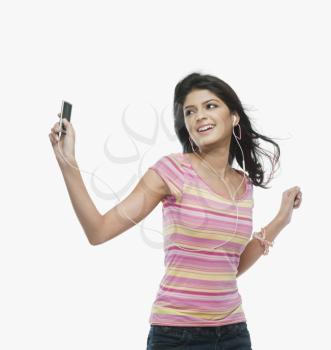 Woman listening to an mp3 player and dancing