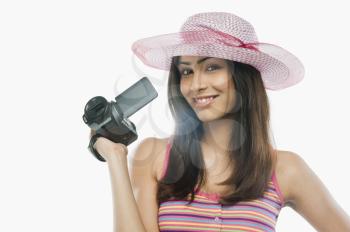 Portrait of a woman filming with a home video camera
