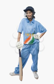 Portrait of a female cricketer standing with a cricket bat