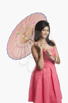Woman holding a parasol and smiling
