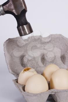 Close-up of a hammer over eggs