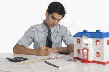 Real estate agent budgeting near a model home