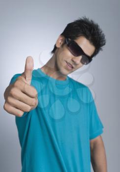 Close-up of a man showing thumbs up