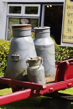 Milk canisters in front of a store, Adare, County Limerick, Republic of Ireland