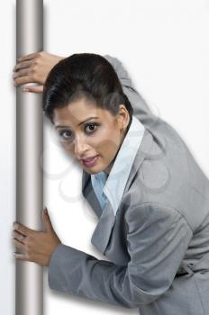 Woman hiding behind a door