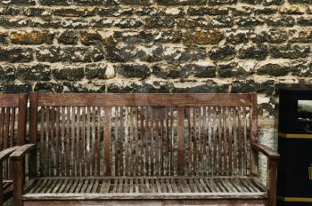 Benches in front of a weathered wall, Oxford, Oxfordshire, England