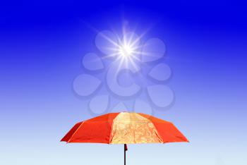 red umbrella under bright sun