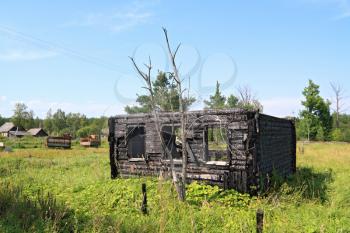 burned rural house on green field