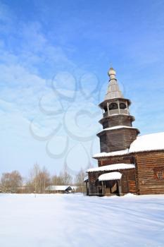 wooden chapel on snow field 