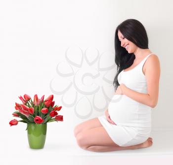 pregnant woman with tulips bouquet