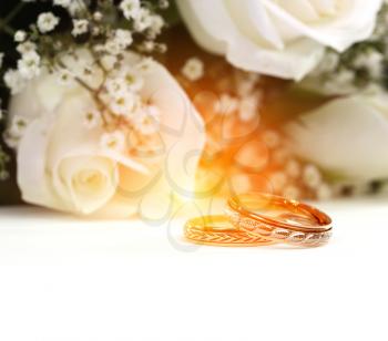 Wedding rings and roses bouquet