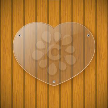 Glass plate in the form of heart on the background of wooden wall