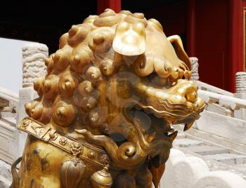 Gold lion near the entrance to Temple in Forbidden City