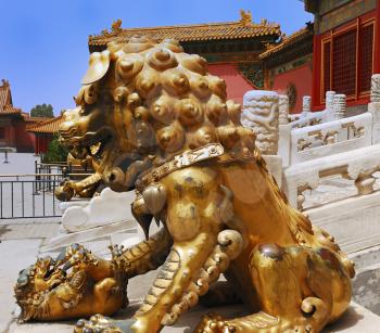 Gold  lion near the entrance to Temple in Forbidden City