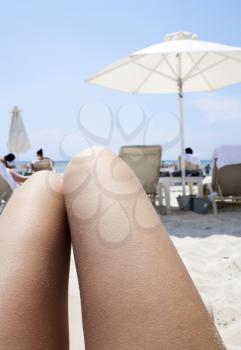 Royalty Free Photo of a Woman's Legs While Laying on the Beach