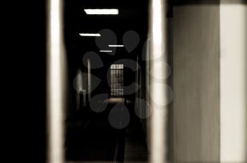 Royalty Free Photo of a Prison Corridor Through Bars
