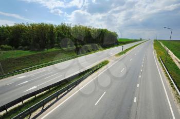 Highway with arrows marking on a sunny day, view from above from the bridge