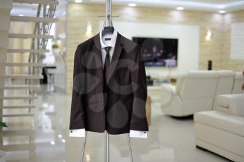 Male suit on stand in a beautiful room.