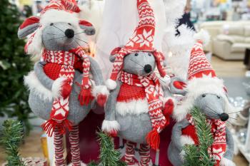 Three gray funny mouse in red hat and scarf, soft toy for Christmas or new year.