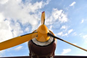 Big propeller on a piston plane against a blue sky