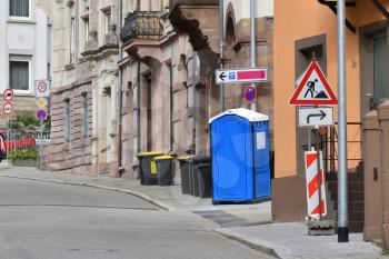 Blue bio toilet on a street in Europe. Bio toilet at the time of repair work on the street
